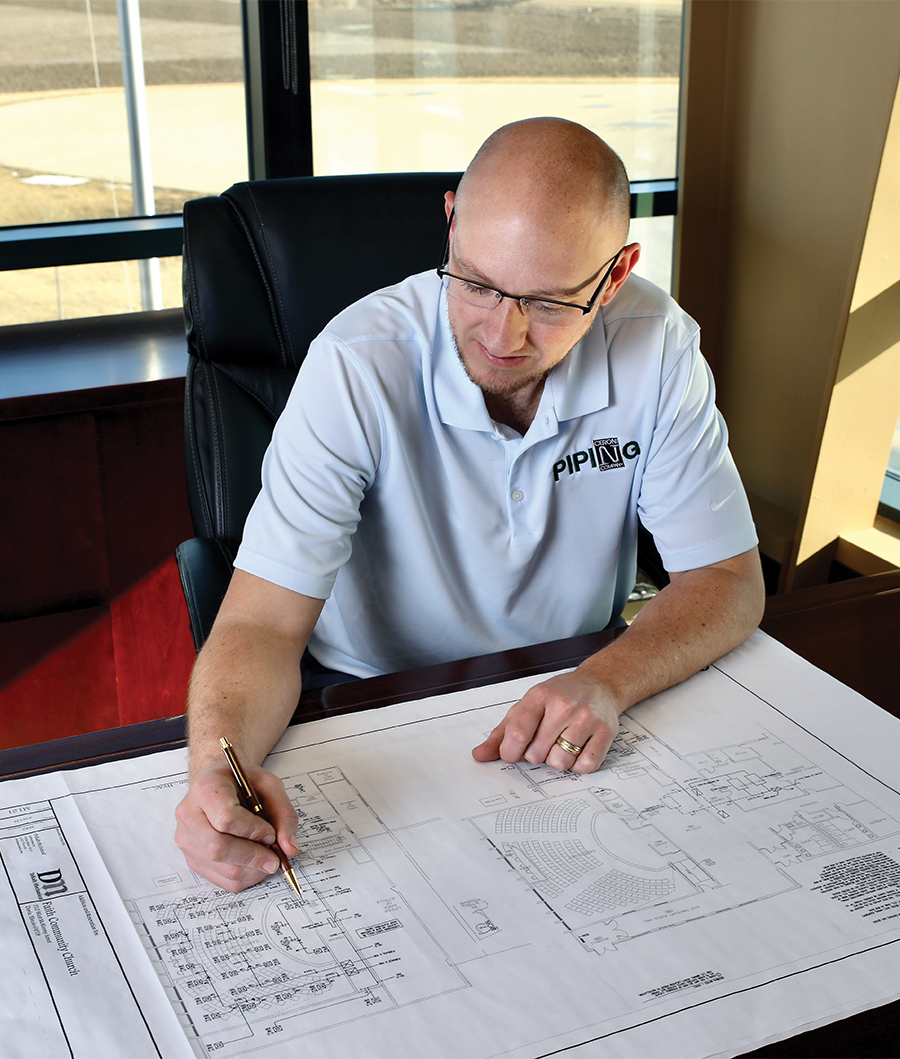 person looking over a blueprint